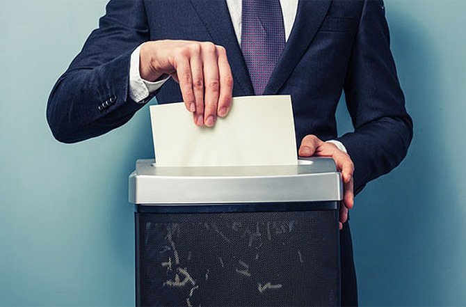 Image showing a man shredding papers with shredder machine